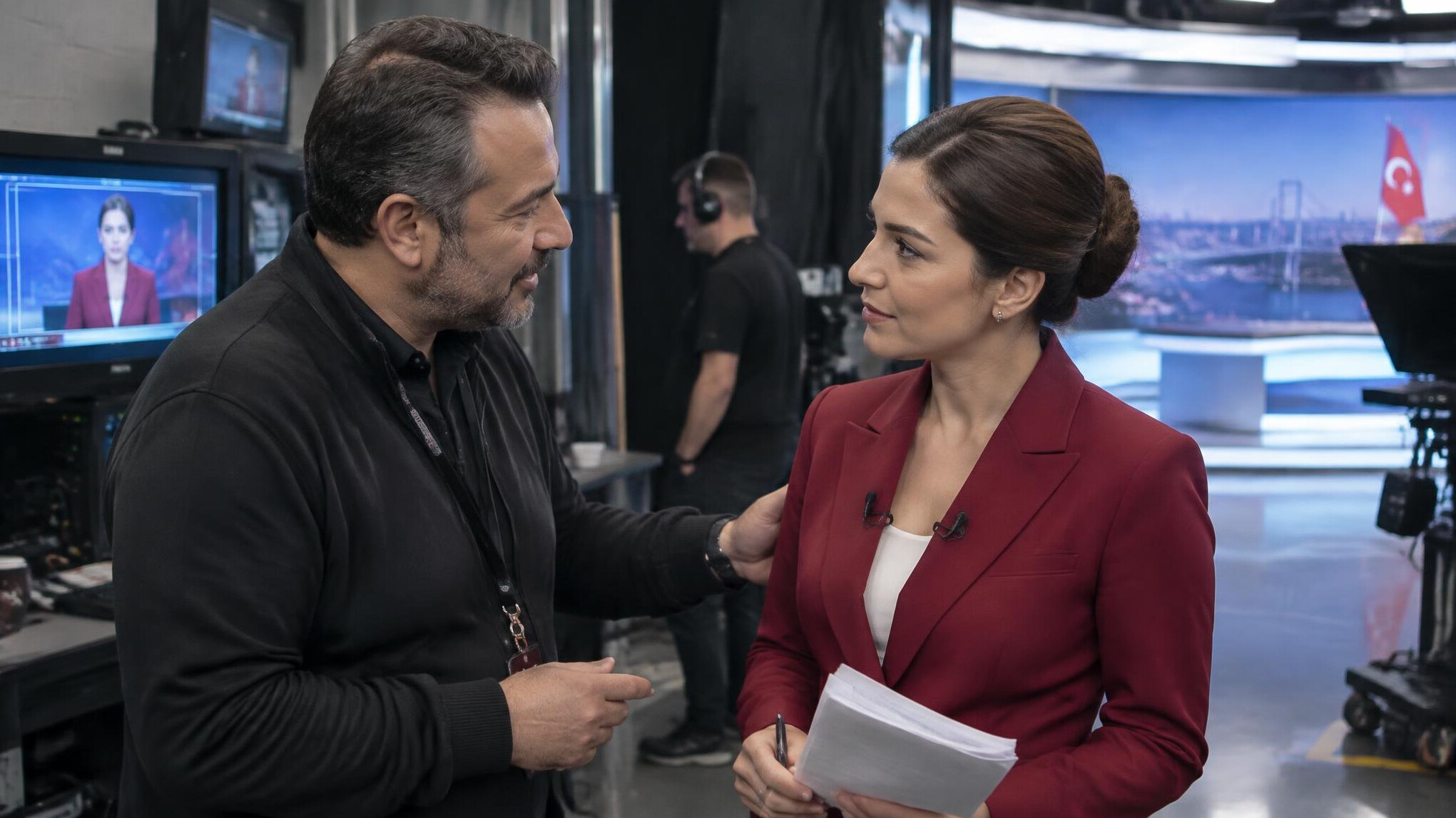 Producer calmly talking with news presenter backstage